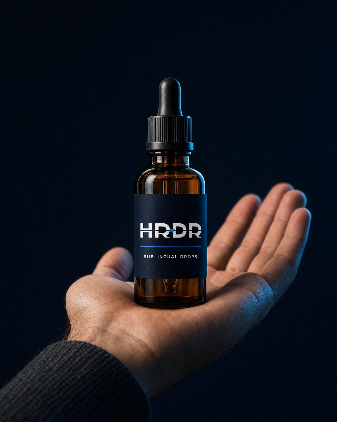 HRDR sublingual dropper vial held in an open hand